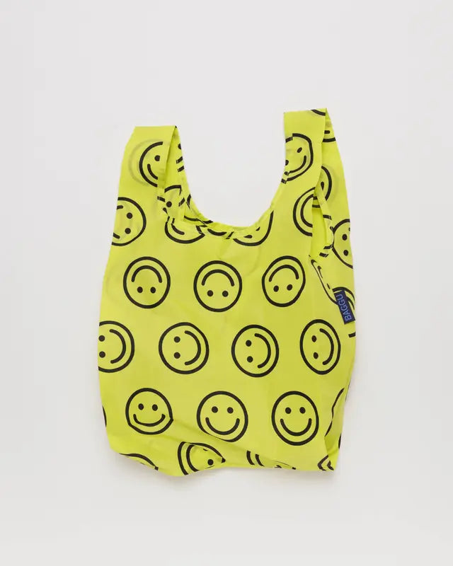 Neon yellow smiley face reusable BAGGU bag on white background 