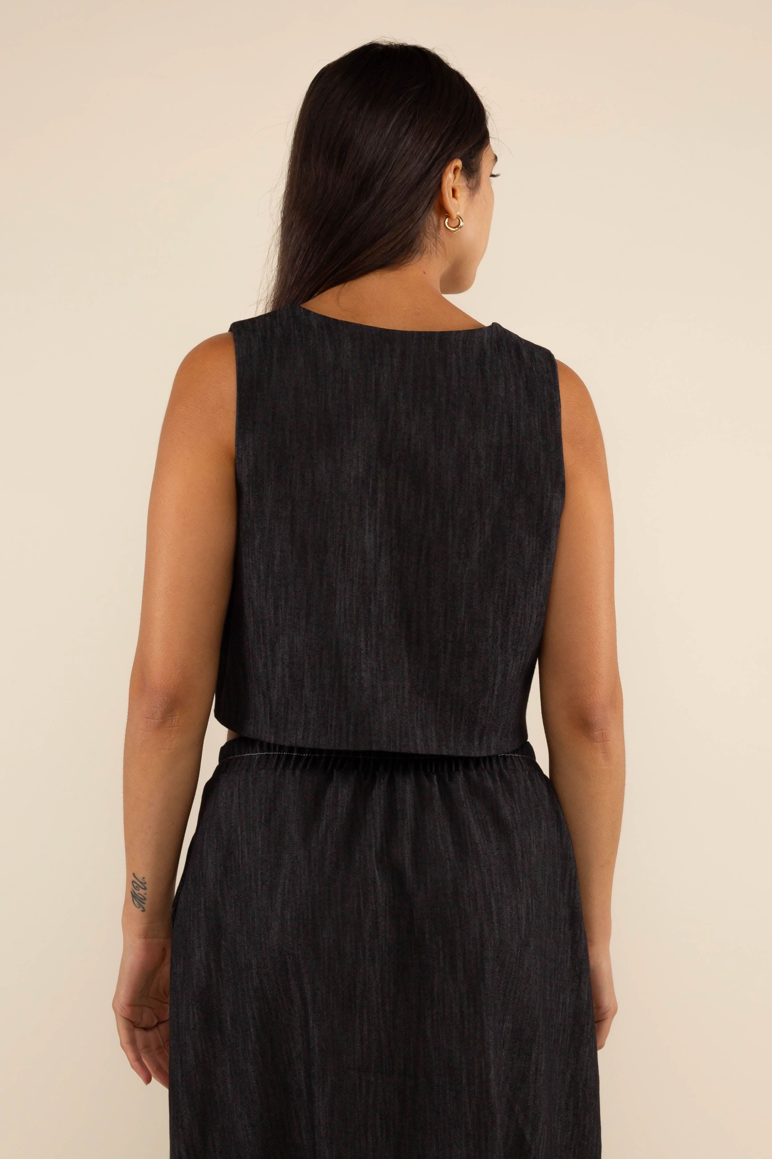 Woman wearing a black sleeveless top and skirt Laney Black Denim Vest