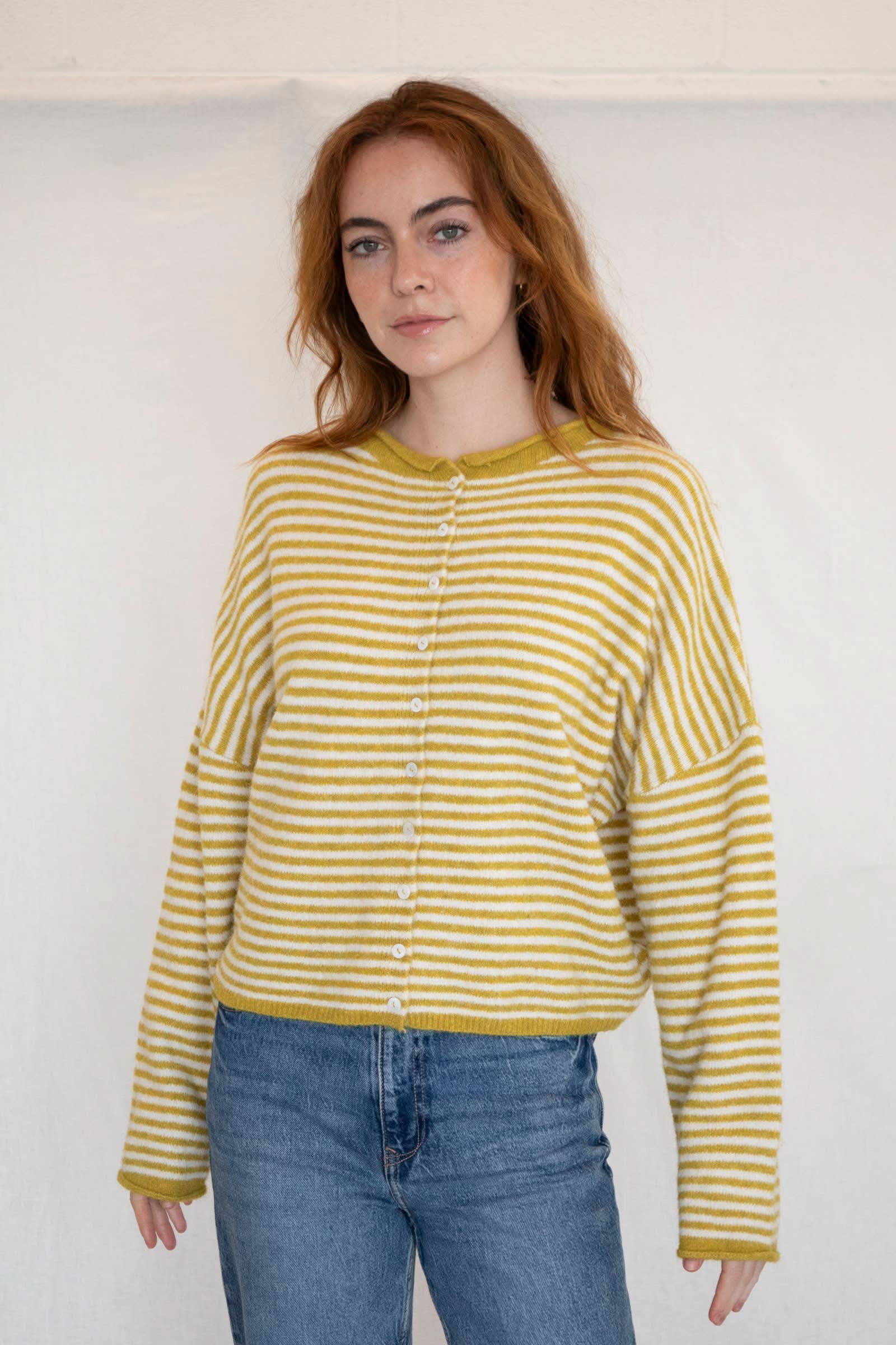 Woman wearing a yellow and white striped sweater 