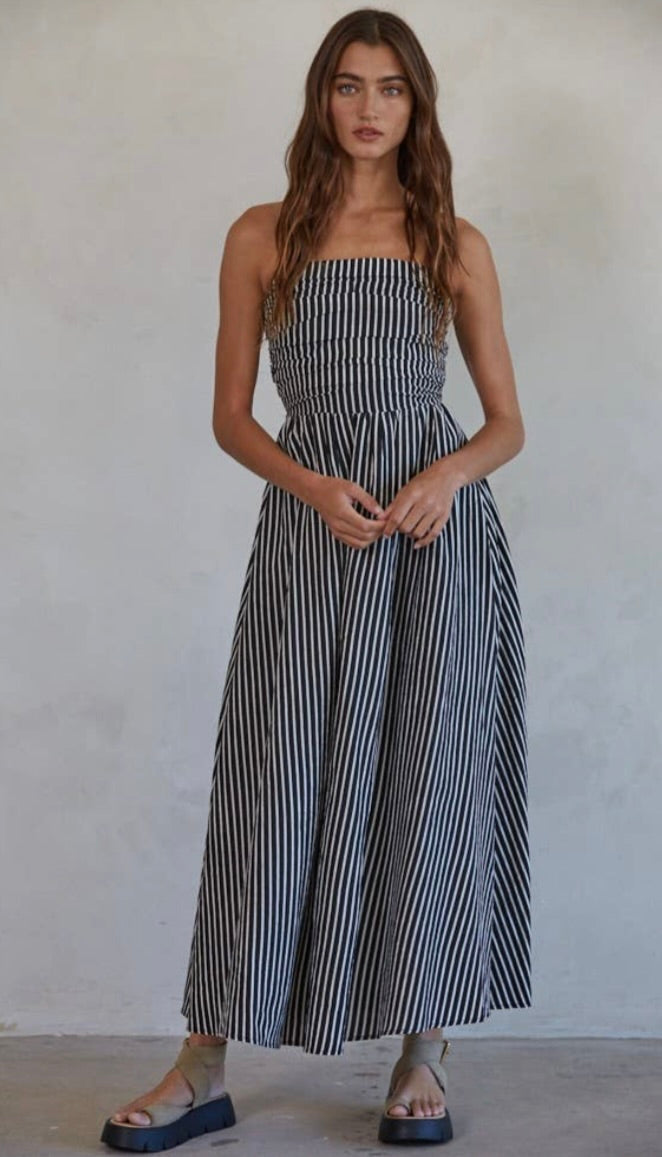 Promenade Maxi Dress Woman wearing a black and white striped dress 
