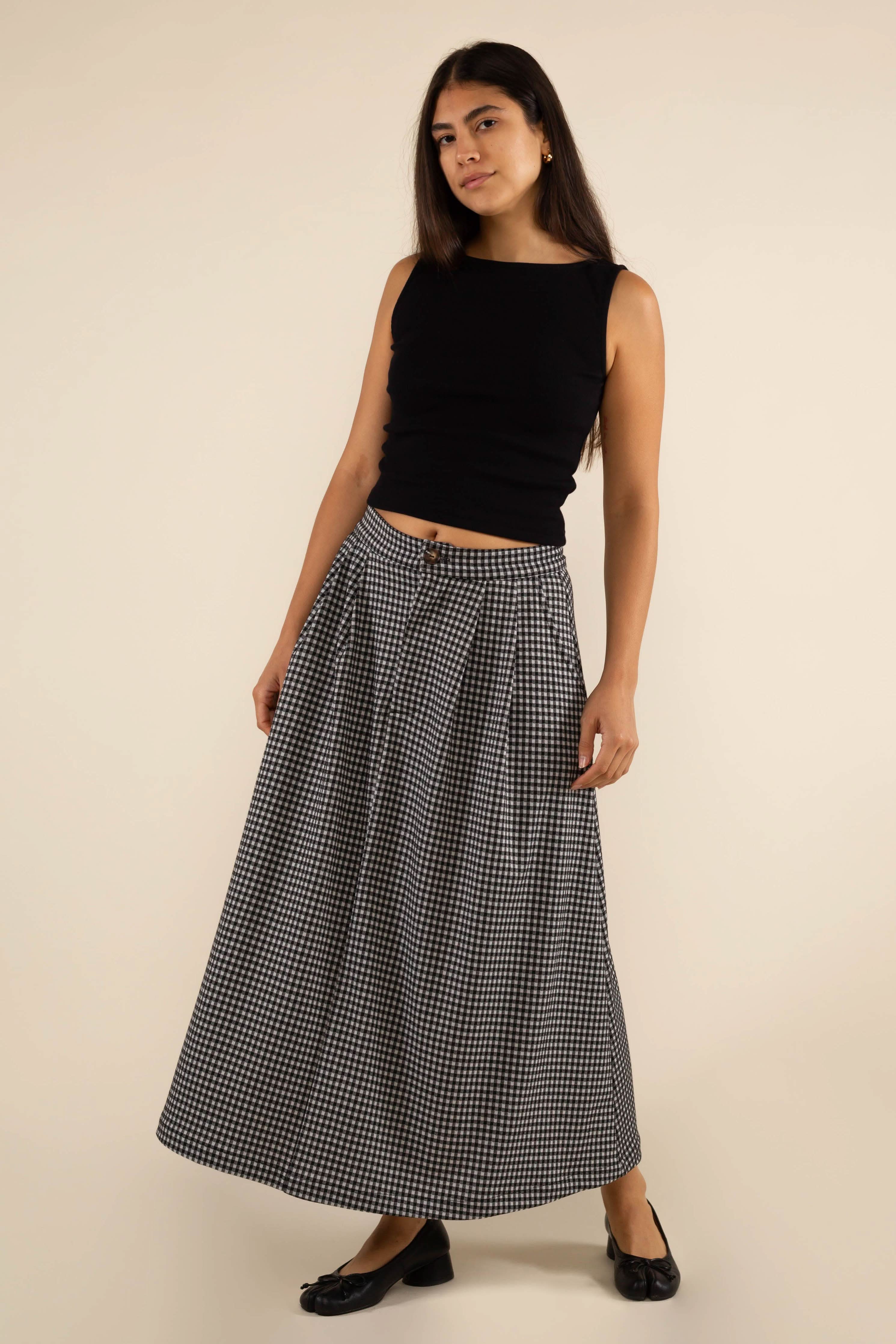 Woman wearing a long checkered skirt 