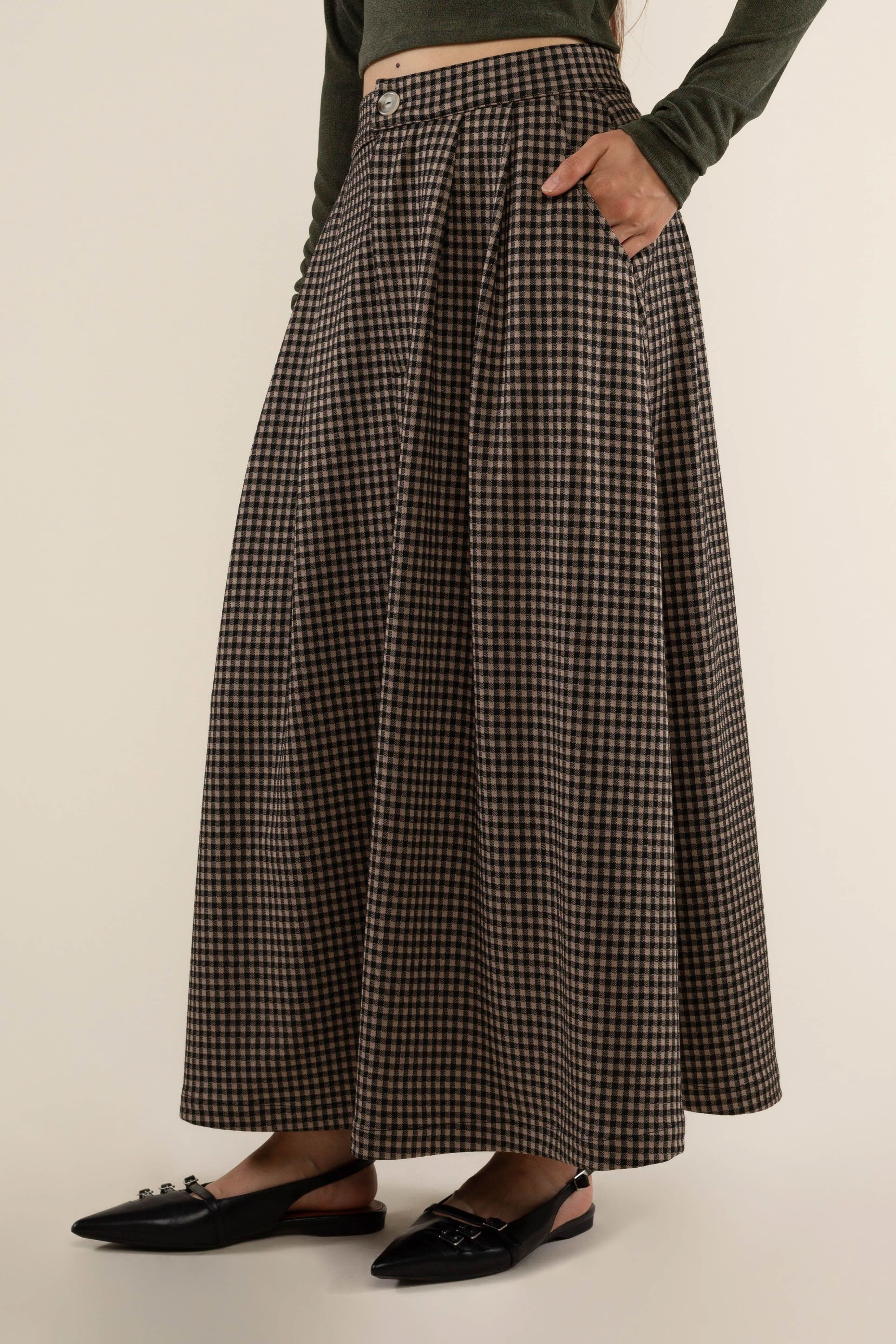 Person wearing a plaid skirt Maxi skirt with zipper and button closure at front. 