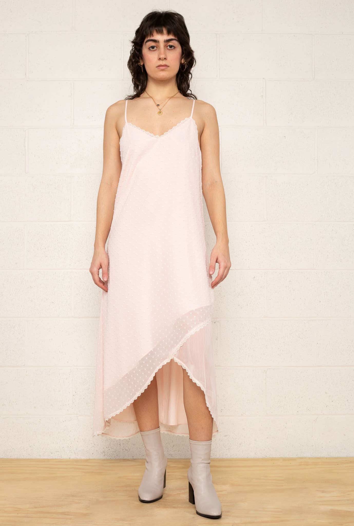 The Flirty Dress Woman wearing a light pink slip dress 