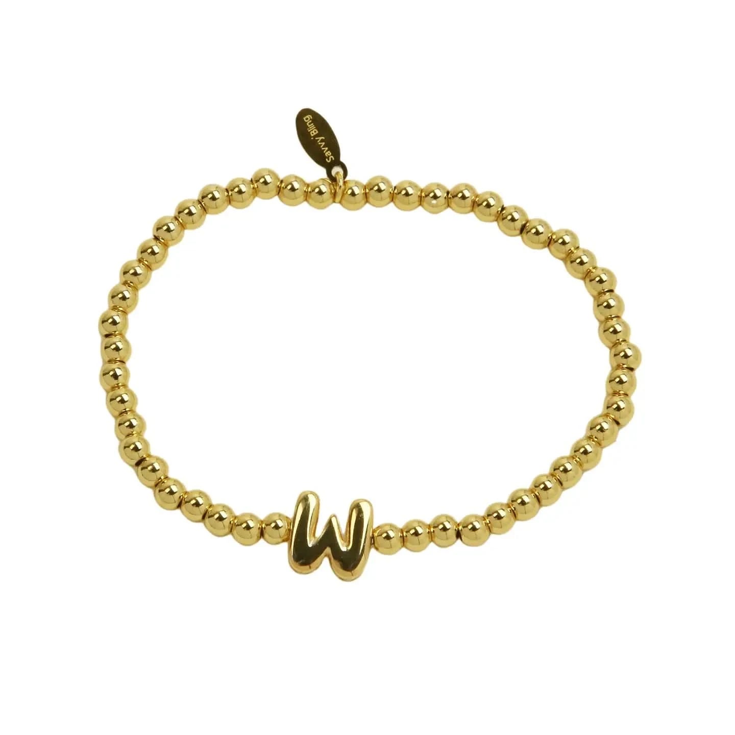 Gold beaded bracelet with a letter 'W' charm on a white background