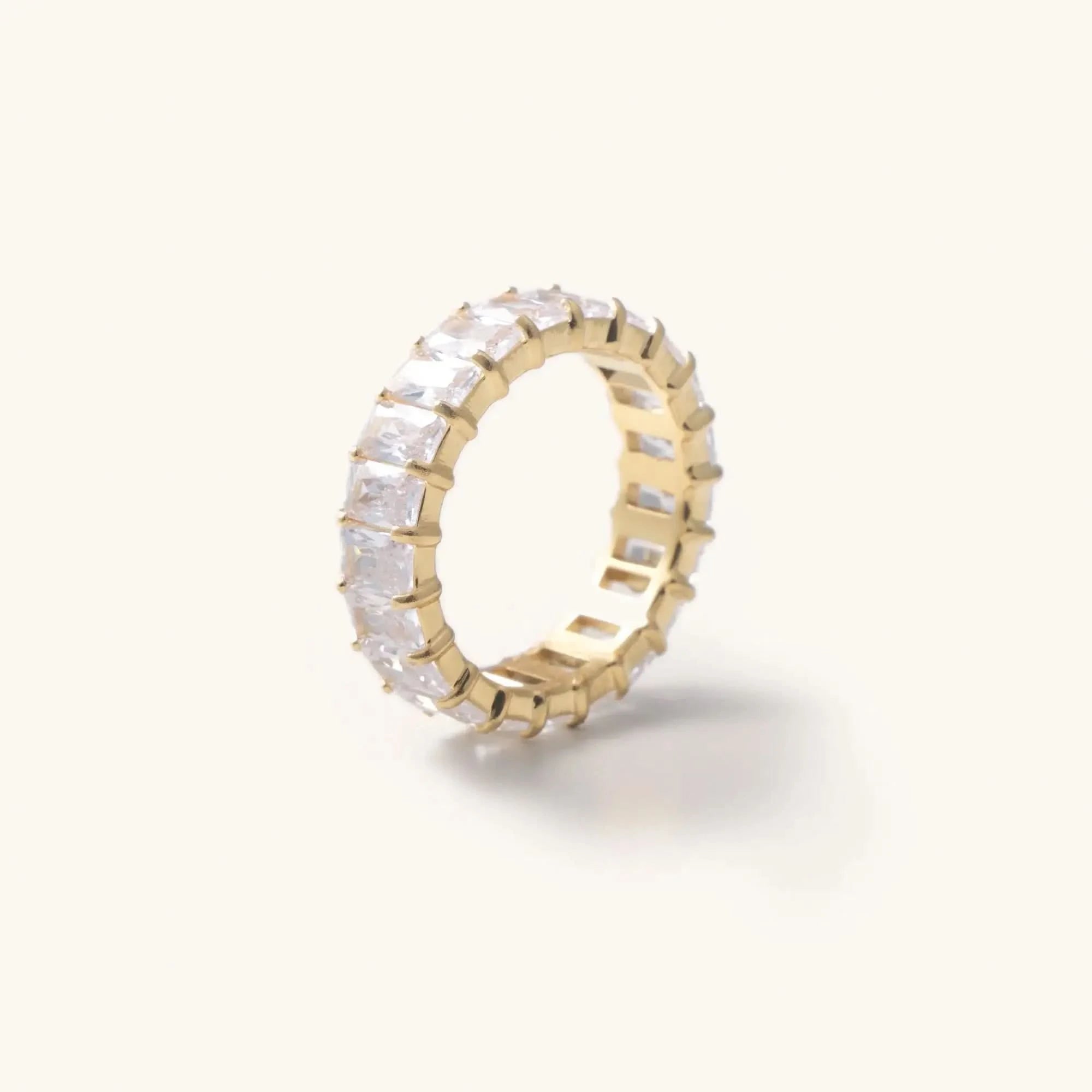 Waterproof gold crystal Cubic zirconia ring laying in a white background 