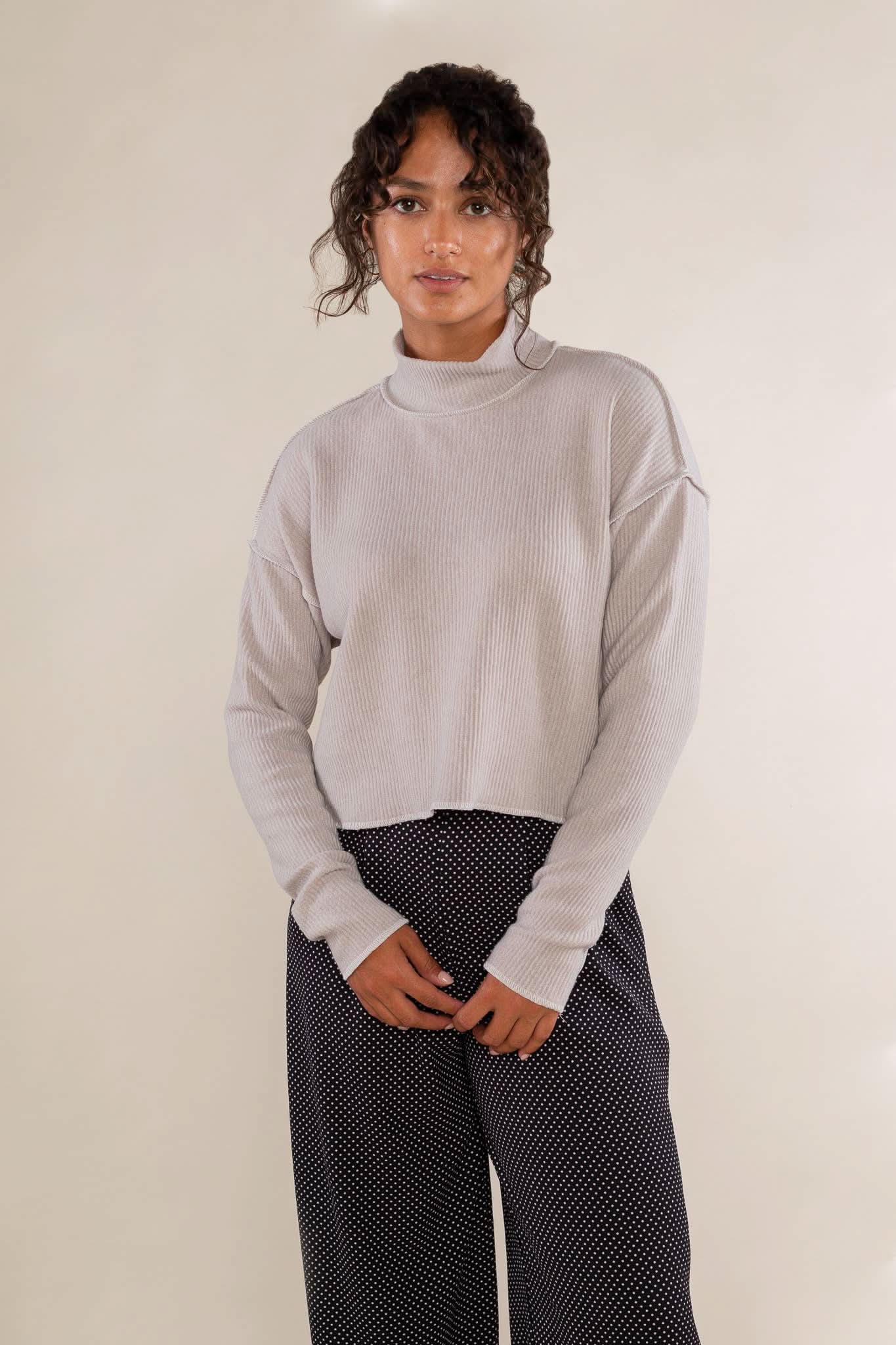 Woman wearing a light gray sweater 